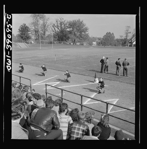 Washington, D.C. Woodrow Wilson High School cheerleaders leading students in a yell at a football game