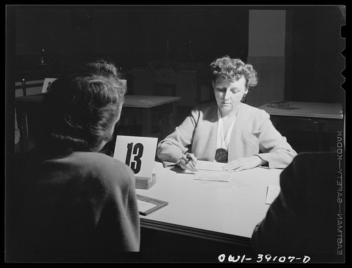 Untitled photo, possibly related to: Washington, D.C. Mrs. Spangler, a Woodrow Wilson faculty member, filling out a ration book application