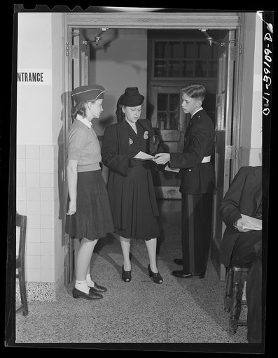 Washington, D.C. An applicant for a ration book being given directions by students at Woodrow Wilson High School