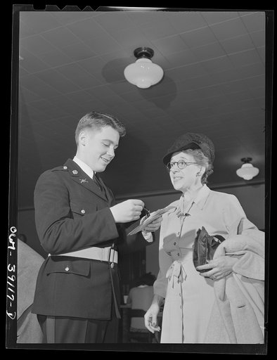 Washington, D.C. A student assisting a ration book applicant at Woodrow Wilson High School