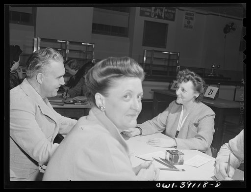 Untitled photo, possibly related to: Washington, D.C. Mrs. Spangler, a Woodrow Wilson faculty member, filling out a ration book application