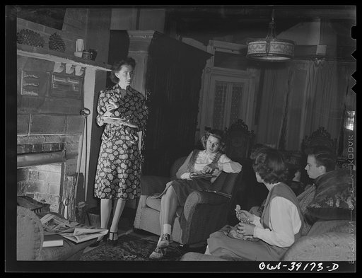 Washington, D.C. Miss Norma Kale, journalism teacher at Woodrow Wilson High School, entertaining some members of the school newspaper staff at her home
