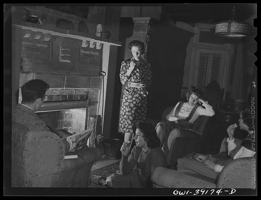 Washington, D.C. Miss Norma Kale, journalism teacher at Woodrow Wilson High School, entertaining some members of the school newspaper staff at her home