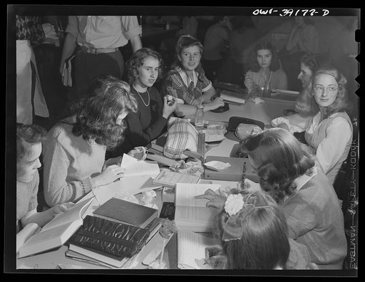 Washington, D.C. Having finished their lunch, these girls catch up on some studying in the cafeteria at Woodrow Wilson High School