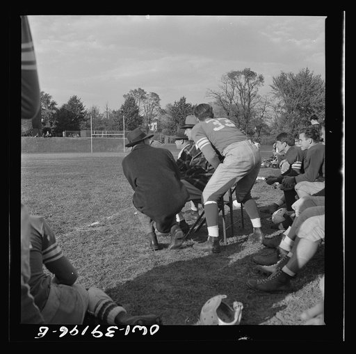 Washington, D.C. A football player at Woodrow Wilson High School getting instructions from the coach before going into the game