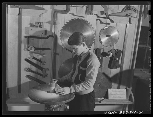 Washington, D.C. Using the sanding machine in the wood shop at Woodrow Wilson High School