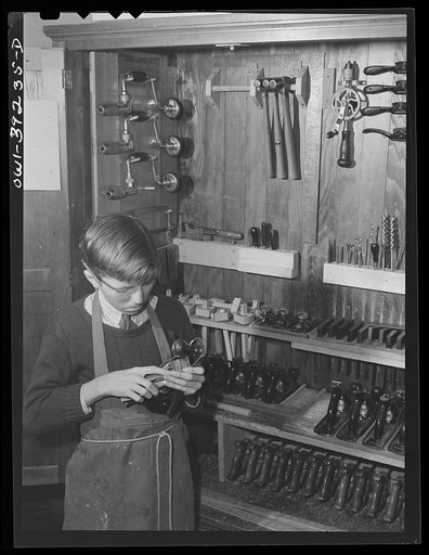 Washington, D.C. Selecting a plane from the tool cabinet in the wood shop