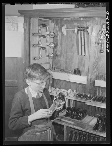 Washington, D.C. Selecting a plane from the tool cabinet in the wood shop