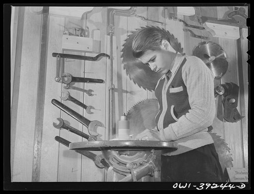Washington, D.C. Using the sanding machine in the wood shop at Woodrow Wilson High School