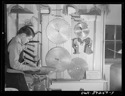 Untitled photo, possibly related to: Washington, D.C. Using the sanding machine in the wood shop at Woodrow Wilson High School