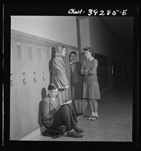 Washington, D.C. Sally Dessez talking with some friends near her locker at Woodrow Wilson High School