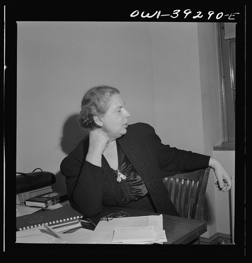 Washington, D.C. Miss Dent, the Woodrow Wilson High School yearbook advisor, listening to plans expounded by the editor and her assistant