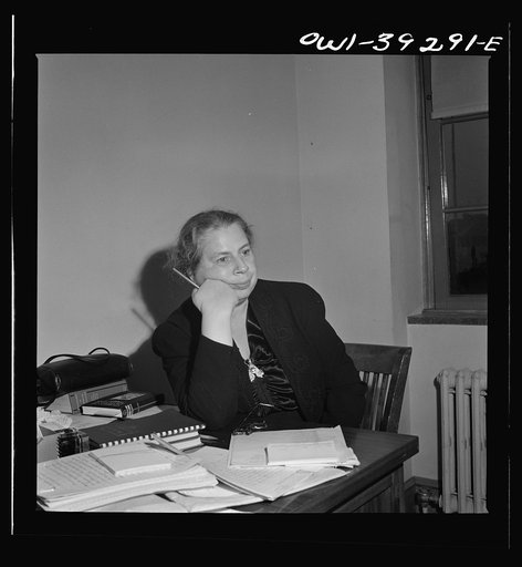 Washington, D.C. Miss Dent, the Woodrow Wilson High School yearbook advisor, listening to plans expounded by the editor and her assistant