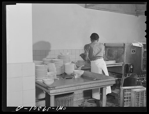 Washington, D.C. A cafeteria employee using the dishwasher in the cafeteria at Woodrow Wilson High School