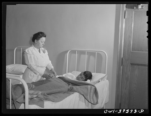 Washington, D.C. The Woodrow Wilson High School nurse checking the pulse of a boy who was sent to the infirmary after fainting in class