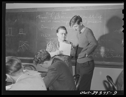 Washington, D.C. Physics teacher at Woodrow Wilson High School explaining a problem to one of her students