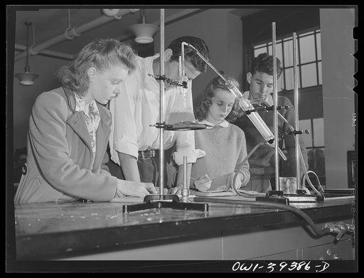 Washington, D.C. Chemistry students making notes in the apparatus used for an experiment at Woodrow Wilson High School