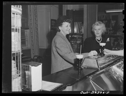 Untitled photo, possibly related to: Washington, D.C. Mrs. Mary Spangler, a Woodrow Wilson High School teacher stopping at a drugstore for a Coca-Cola before going to a meeting with a school supervisor
