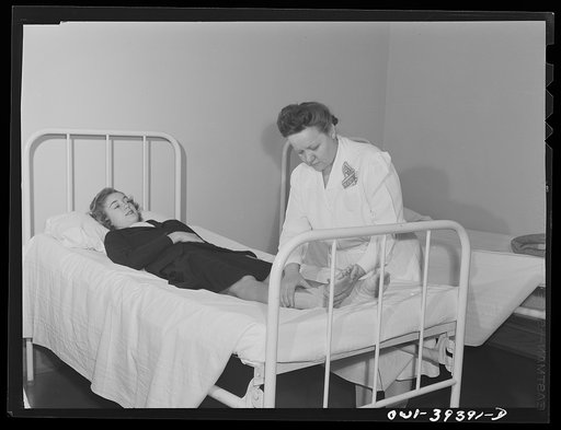Washington, D.C. The Woodrow Wilson High School nurse examining the foot of a student who was hurt in a gymnasium class