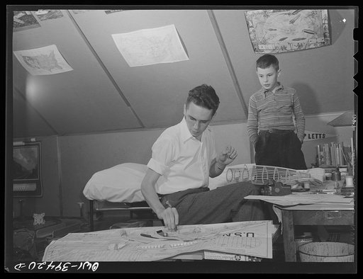 Washington, D.C. Walter Spangenberg, a student at Woodrow Wilson High School, with his nine year-old brother as he works on a model airplane at home