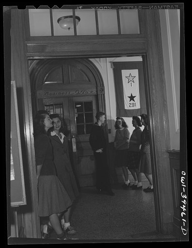 Untitled photo, possibly related to: Washington, D.C. A former student talking to friends in the front hall at Woodrow Wilson High School