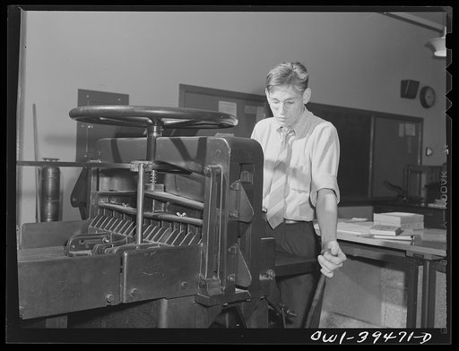 Washington, D.C. Using the paper cutter in a printing class at Woodrow Wilson High School