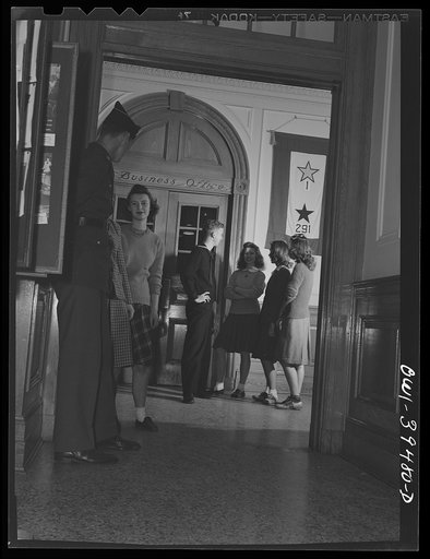 Untitled photo, possibly related to: Washington, D.C. A former student talking to friends in the front hall at Woodrow Wilson High School