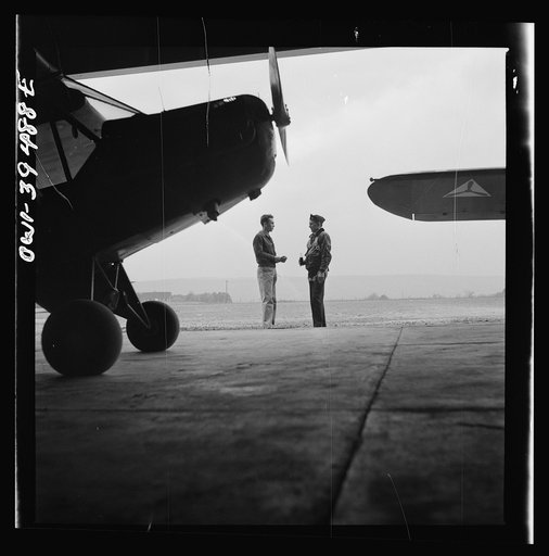 Untitled photo, possibly related to: Frederick, Maryland. Walter Spangenberg, a student at Woodrow Wilson High School, talking to a friend at the Stevens Airport where he takes lessons