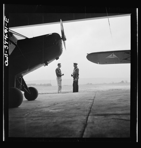 Frederick, Maryland. Walter Spangenberg, a student at Woodrow Wilson High School, talking to a friend at the Stevens Airport where he takes flying lessons