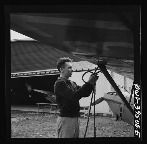 Frederick, Maryland. Returning from a practice flight at Stevens Airport, Walter Spangenberg, a student at Woodrow Wilson High School, ties down his plane