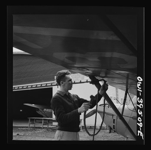 Untitled photo, possibly related to: Frederick, Maryland. Returning from a practice flight at Stevens Airport, Walter Spangenberg, a student at Woodrow Wilson High School, ties down his plane