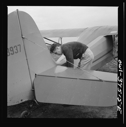 Frederick, Maryland. Returning from a practice flight at Stevens Airport, Walter Spangenberg, a student at Woodrow Wilson High School, ties down his plane