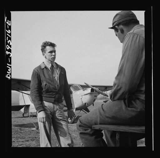 Frederick, Maryland. After a solo flight, Walter Spangenberg, a student at Woodrow Wilson High School, listens to a criticism from his instructor at Stevens Airport