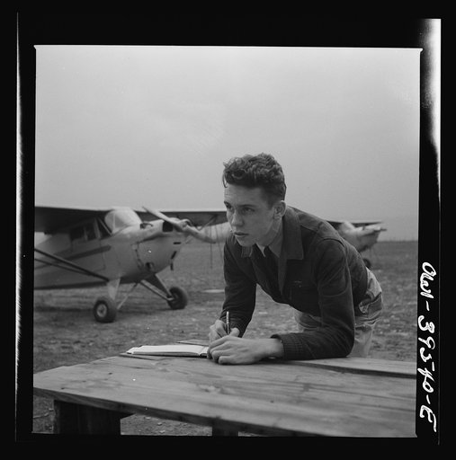 Frederick, Maryland. Walter Spangenberg, a student at Woodrow Wilson High School, filling out his pilot's log book at the Stevens Airport