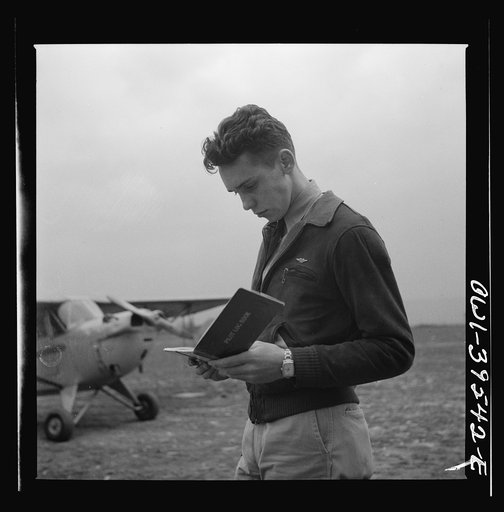 Untitled photo, possibly related to: Frederick, Maryland. Walter Spangenberg, a student at Woodrow Wilson High School, filling out his pilot's log book after a solo flight at the Stevens Airport