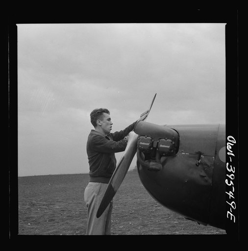 Untitled photo, possibly related to: Frederick, Maryland. Walter Spangenberg, a student at Woodrow Wilson High School, spinning the propeller for a fellow student at the Stevens Airport