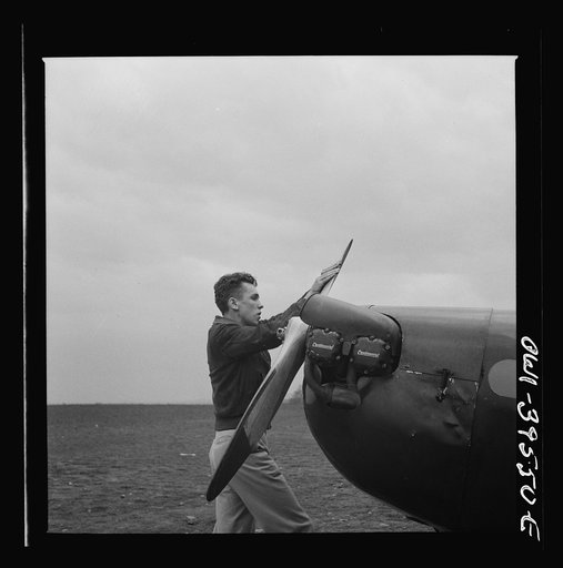 Frederick, Maryland. Walter Spangenberg, a student at Woodrow Wilson High School, spinning the propeller for a fellow student at the Stevens Airport