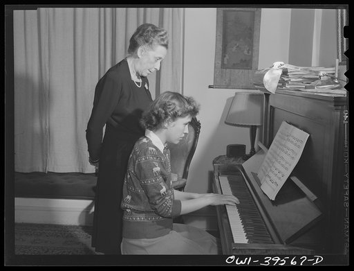 Washington, D.C. Sally Dessez, a student at Woodrow Wilson High School, getting a suggestion from her aunt on the improvement of her technique as she practices the piano at home