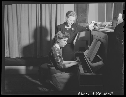 Untitled photo, possibly related to: Washington, D.C. Sally Dessez, a student at Woodrow Wilson High School, playing the piano as her father and aunt listen