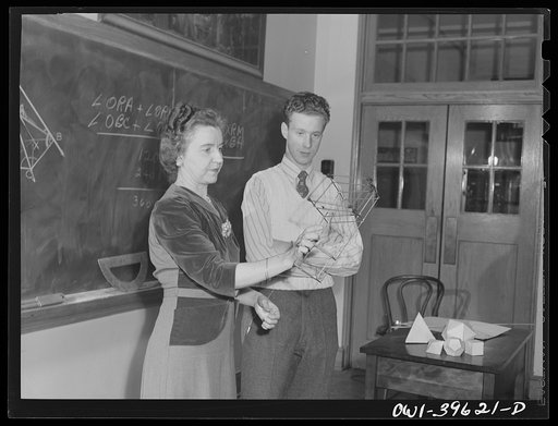 Washington, D.C. A geometry teacher at Woodrow Wilson High School using a model to explain a figure