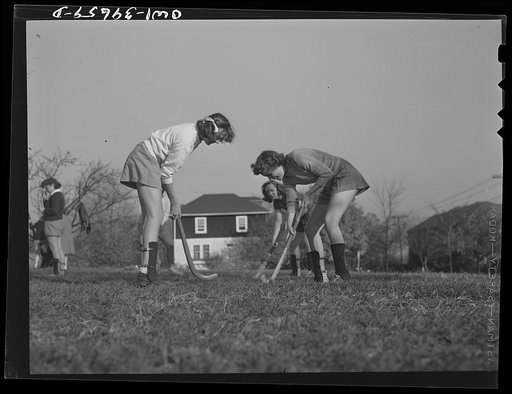 Untitled photo, possibly related to: Washington, D.C. Sally Dessez (on the left), a student at Woodrow Wilson High School, playing hockey