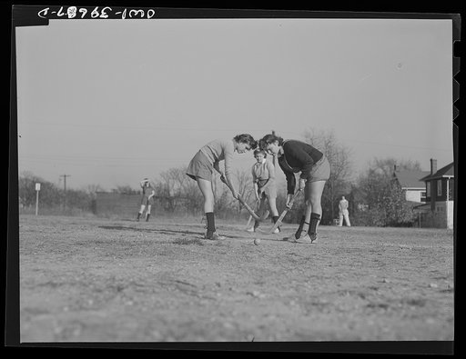 Washington, D.C. Sally Dessez (in the light sweater), a student at Woodrow Wilson High School, "bullying up" in a hockey game