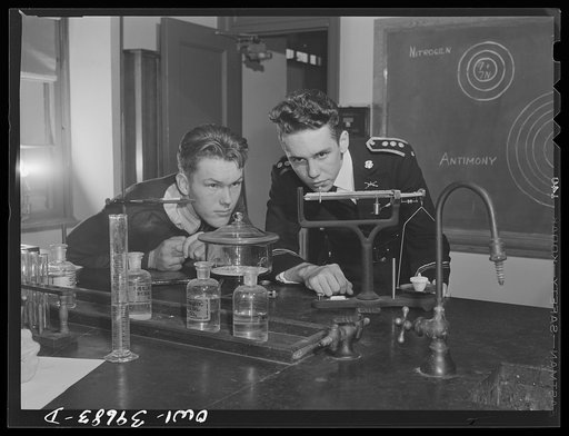 Washington, D.C. Walter Spangenberg, a student at Woodrow Wilson High School, working in the chemistry laboratory. When the cadets drill, he wears his uniform all day