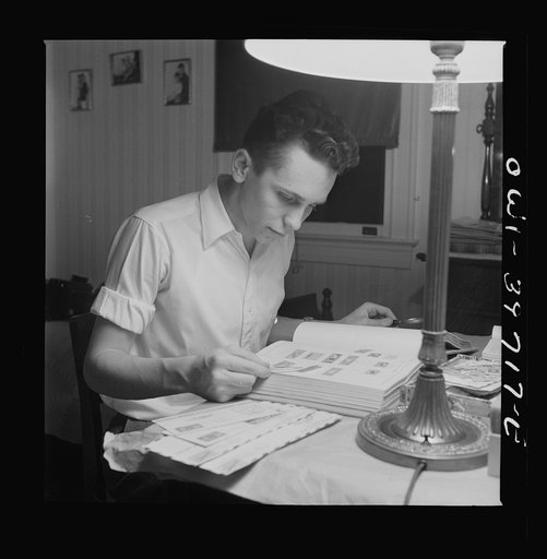 Washington, D.C. Walter Spangenberg, a student at Woodrow Wilson High School, working on his stamp collection