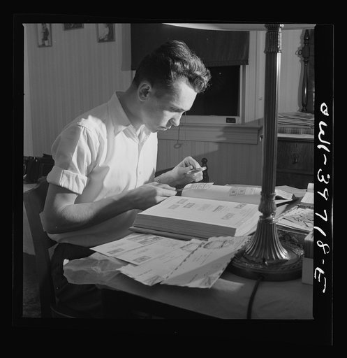 Washington, D.C. Walter Spangenberg, a student at Woodrow Wilson High School, working on his stamp collection