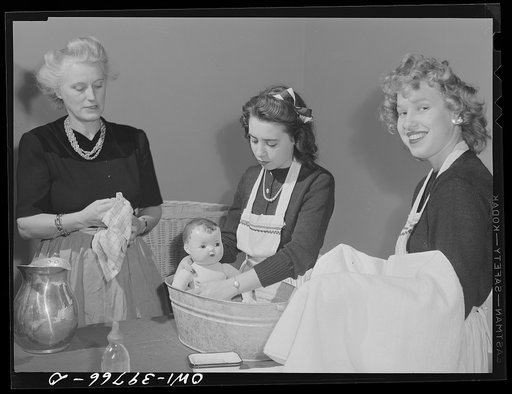 Untitled photo, possibly related to: Washington, D.C. Home economics students at Woodrow Wilson High School learning baby care practicing with a large doll