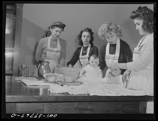 Washington, D.C. Home economics students at Woodrow Wilson High School learning baby care practicing with a large doll