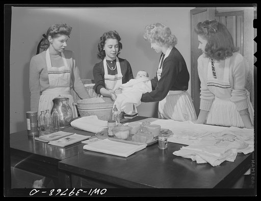 Washington, D.C. Home economics students at Woodrow Wilson High School learning baby care practicing with a large doll