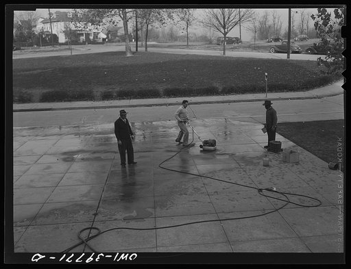 Washington, D.C. The custodial force cleaning the Woodrow Wilson High School sidewalk of the red paint applied by students of a rival school before a football game