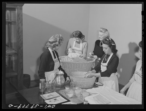 Washington, D.C. Home economics students at Woodrow Wilson High School learning baby care practicing with a large doll